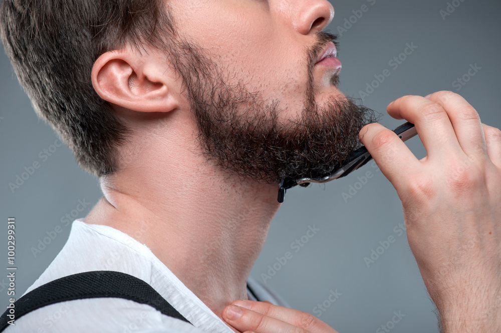 Healthy bearded young guy with sharp razor Healthy bearded young guy with sharp razor