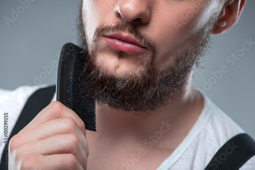 Konstfotografi Healthy young guy with hairbrush in his hands