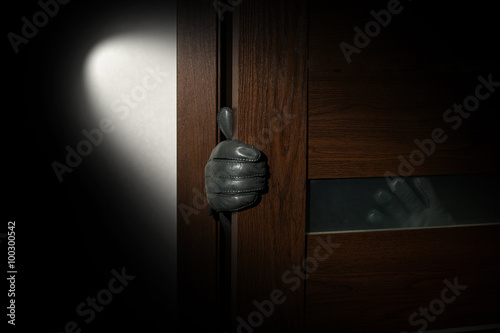 man's hand in a black glove open the door photo