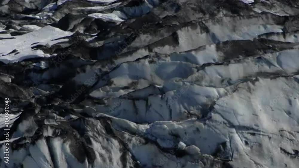 View of the side of a glacier and snow covered mountain in Glacier Bay, Alaska.