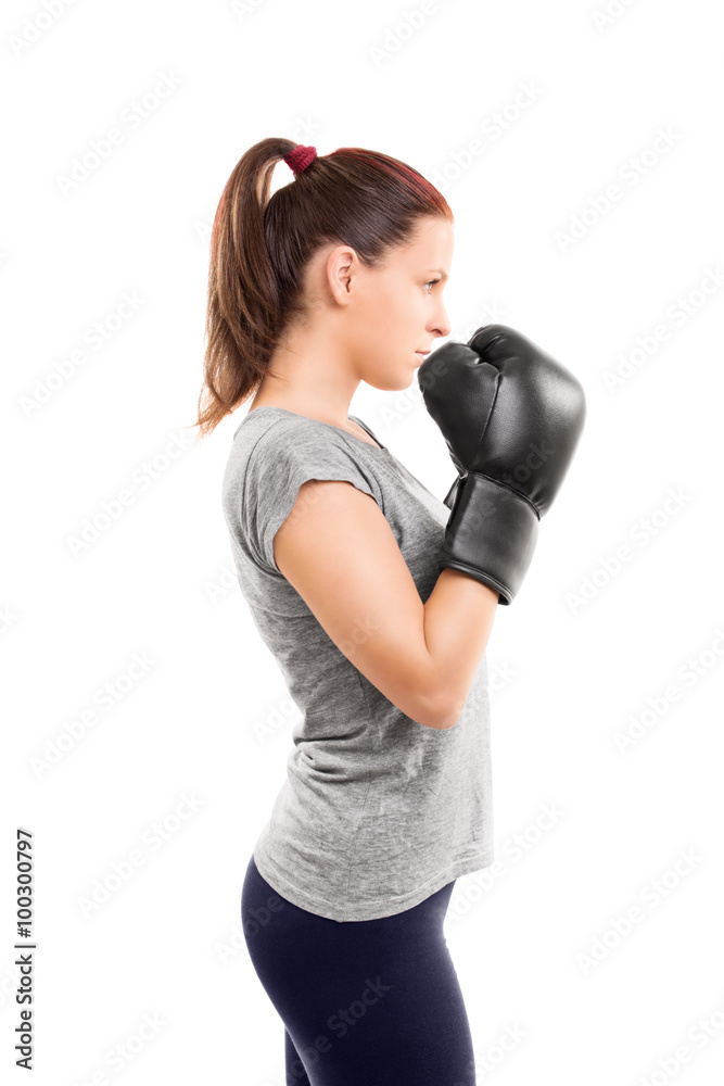 Young girl with boxing gloves holding her guard up