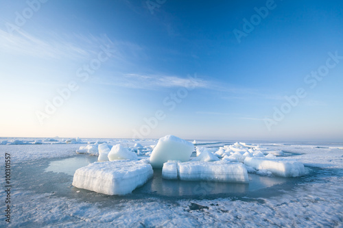 Ice hummocks swim in the sea photo