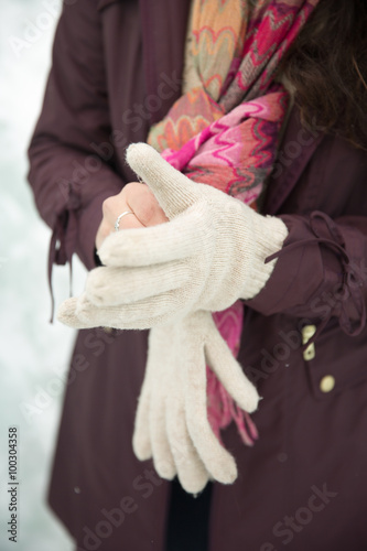 woman putting on gloves