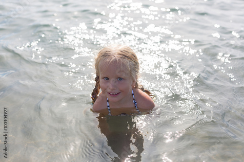 happy girl sitting in the sea