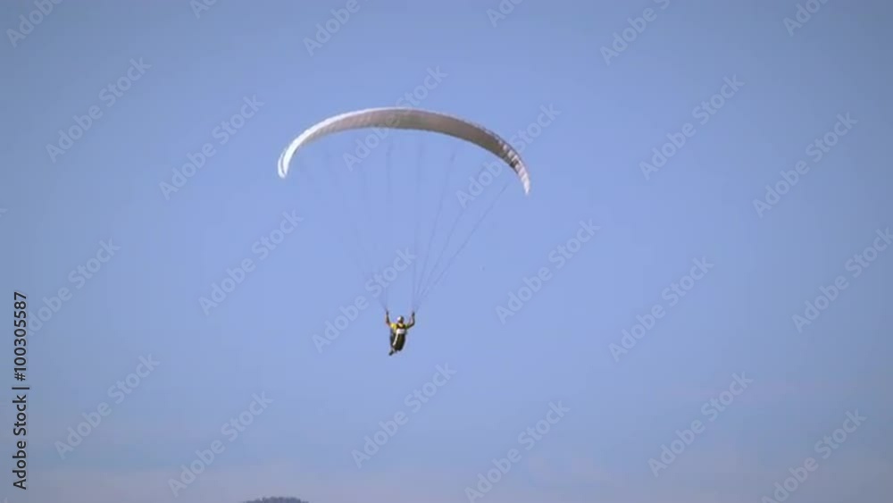 Paraglider is soaring through the air, soon joined by hang glider. Paraglider is soaring through the air, soon joined by hang glider.