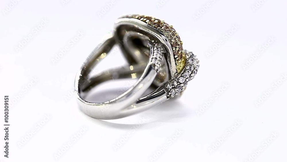 Excellence Ring in Yellow and White Gold and Diamonds Turning on Themselves Against a White Background Excellence Ring in Yellow and White Gold and Diamonds Turning on Themselves Against a White Background