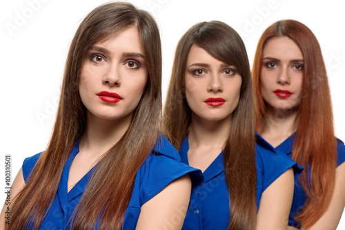 three long-haired women. triplets sisters