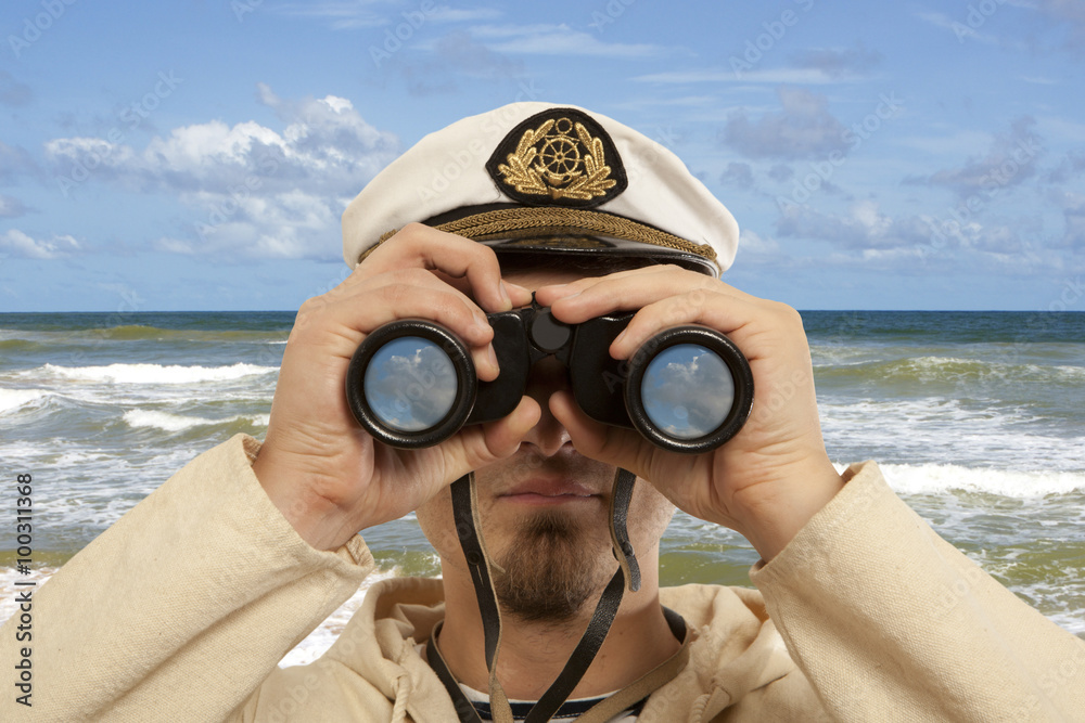 Captain looks through a binoculars
