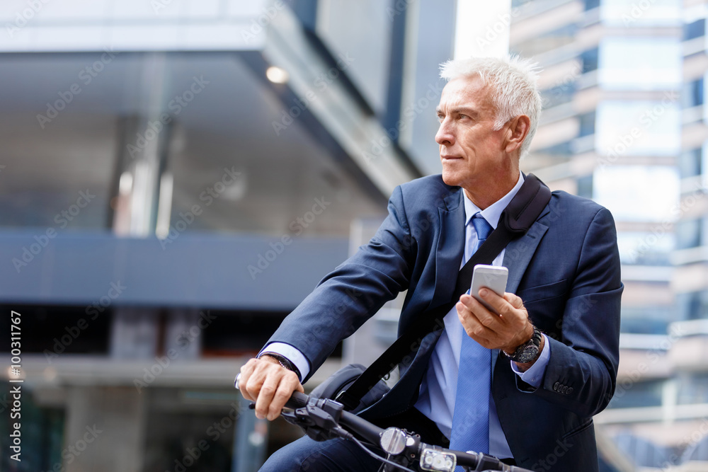 Successful businessman riding bicycle Successful businessman riding bicycle