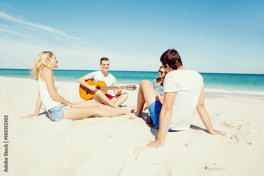 Beautiful young people with guitar on beach