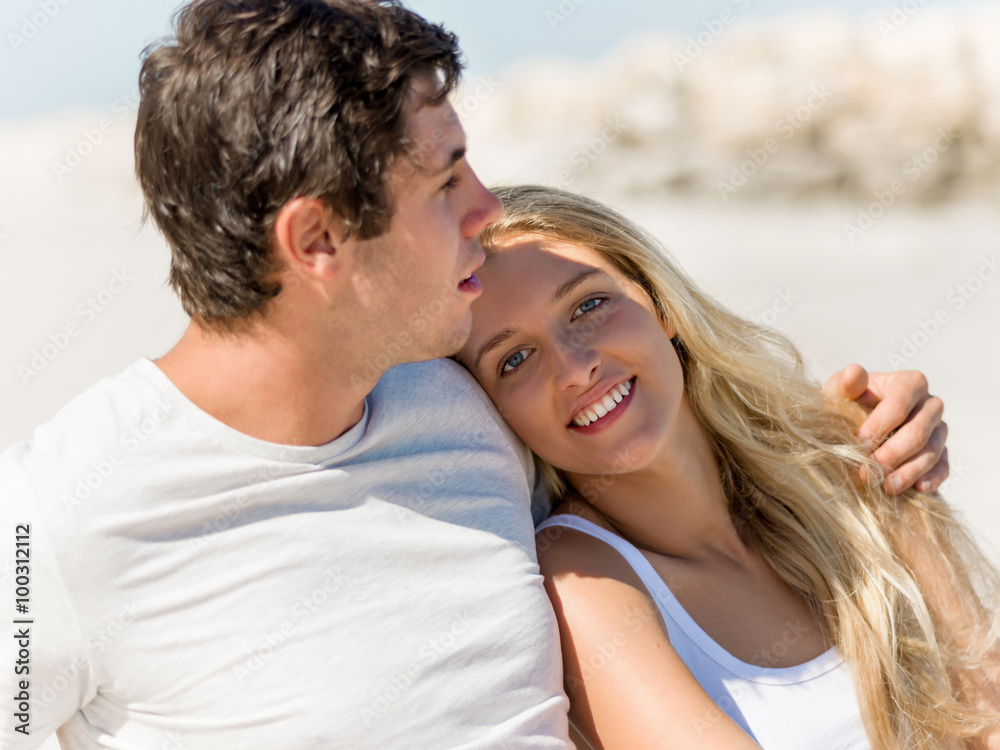 Romantic young couple sitting on the beach Romantic young couple sitting on the beach