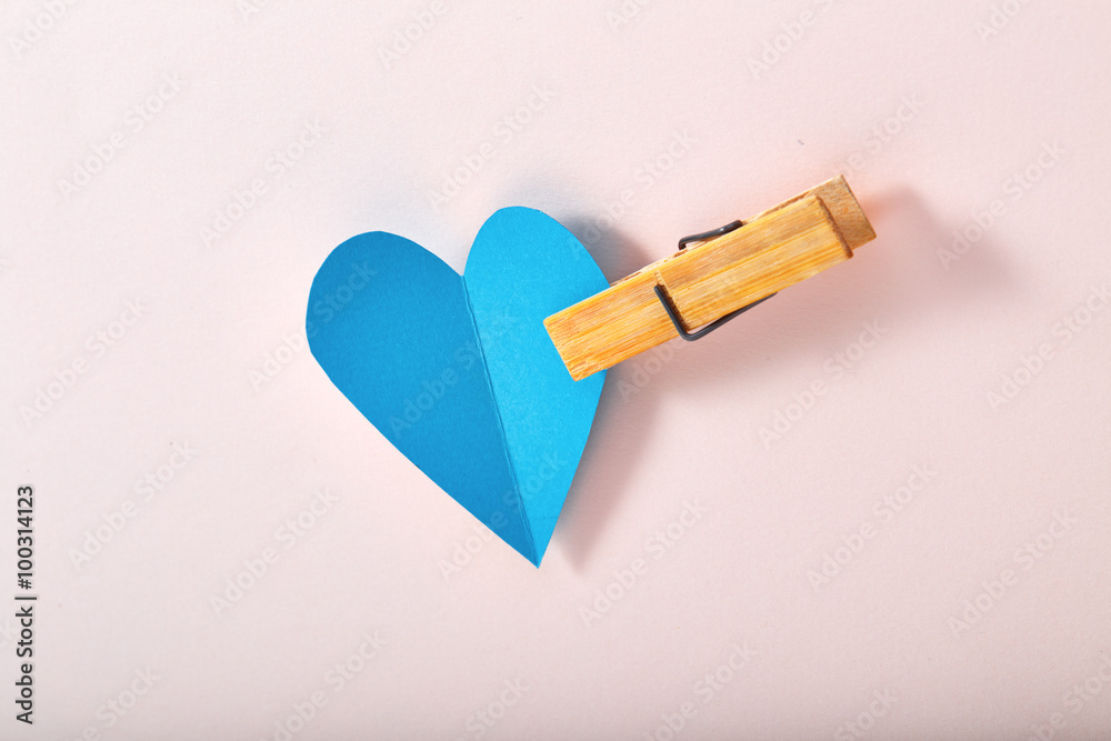 Blue paper heart on pink paper Blue paper heart on pink paper