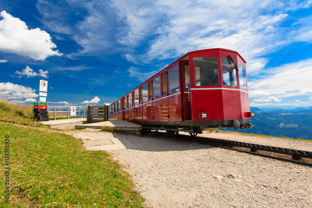 Obraz premium Steam train in a beautiful alpine landscape.
