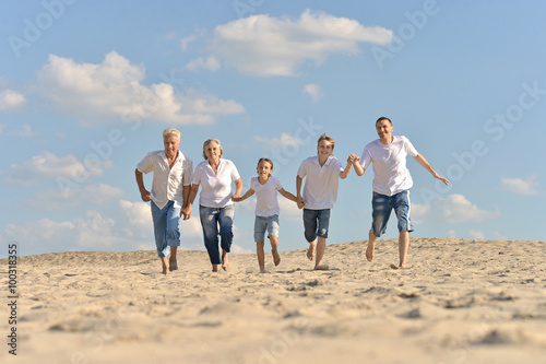  Boys with parents running on sand