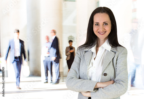 Beautiful business woman portrait and people blur on the background. Modern business life concept photo