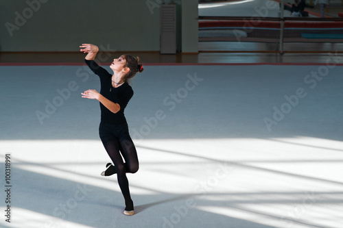 girl dancing in hall rhythmic gymnastics