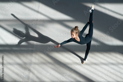  little girl doing balance on  rhythmic gymnastics photo