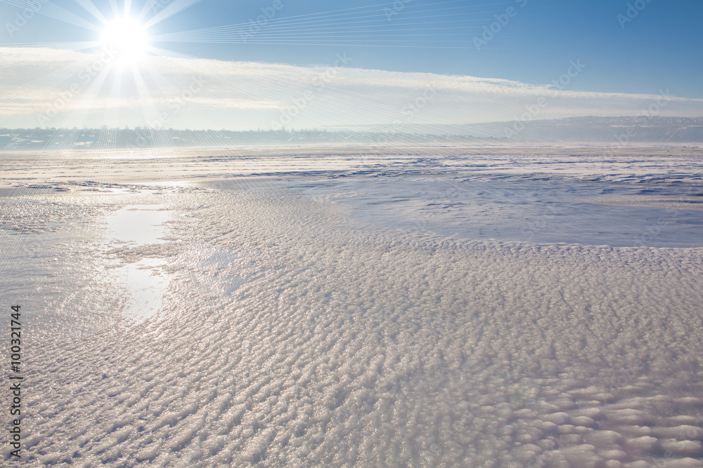 cold sun over frozen lake