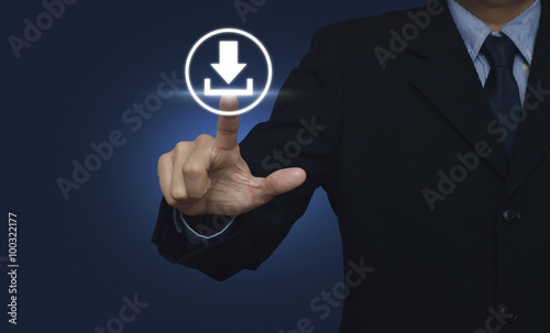 Businessman hand pushing button web download icon over blue back photo