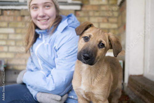 Teen girl with a young funny dog