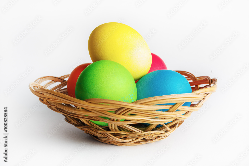 Colorful easter eggs in a wicker basket.