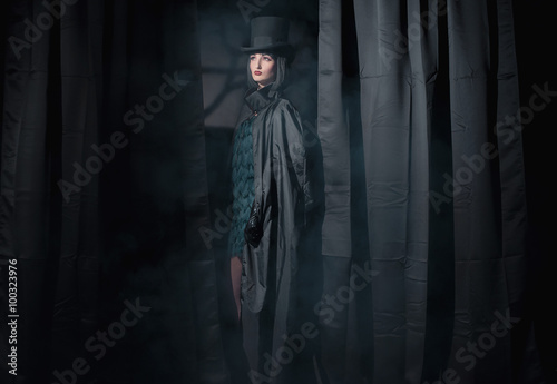 Witch fashion woman wearing black cape and hat. Standing between