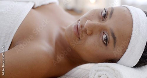 Young woman relaxing and lying at health spa club