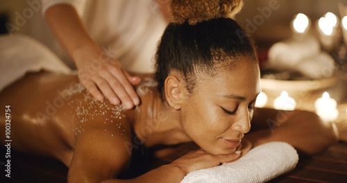 African-american woman getting a relaxing massage in salon in slow motion