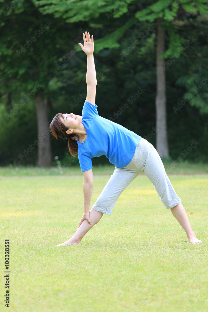 Japanese woman doing yoga triangle pose Japanese woman doing yoga triangle pose