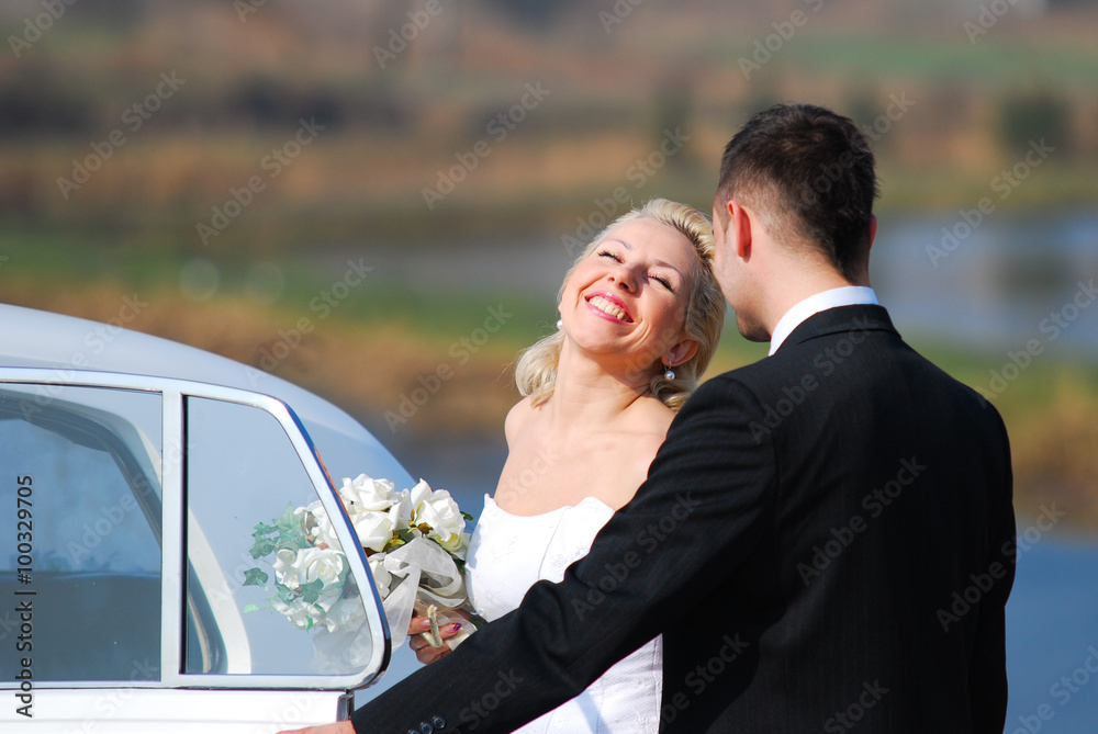 bride smiling at the groom and getting into the white rolls-royce car bride smiling at the groom and getting into the white rolls-royce car