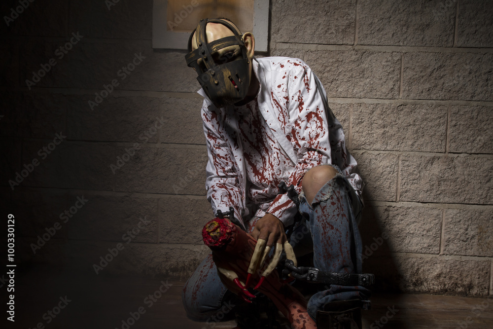 horror, Man chained with blood and knife, has a severed leg bloo