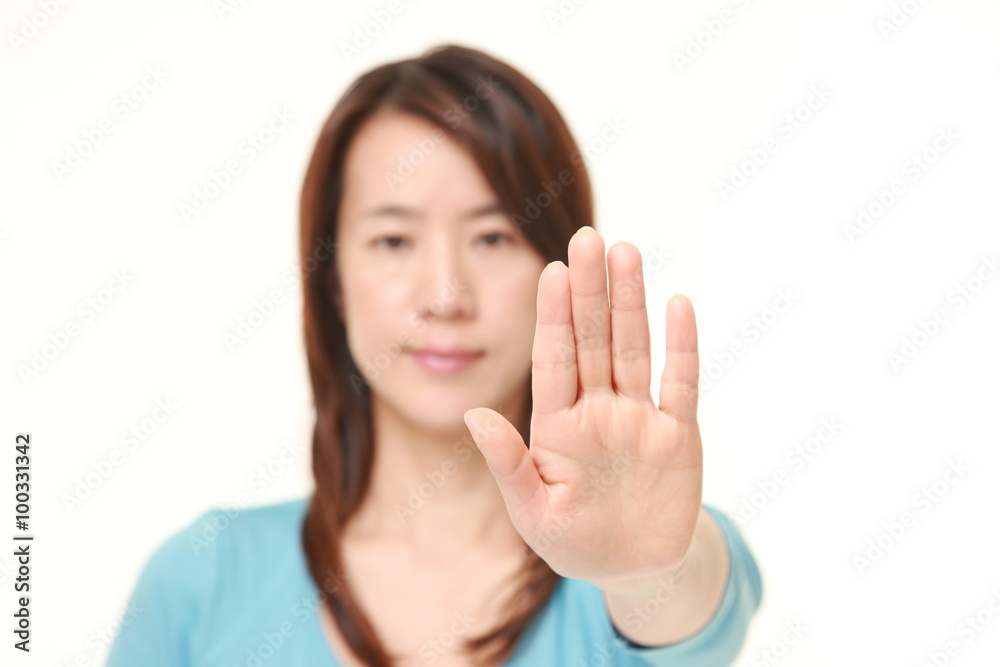 Japanese woman making stop gesture Japanese woman making stop gesture