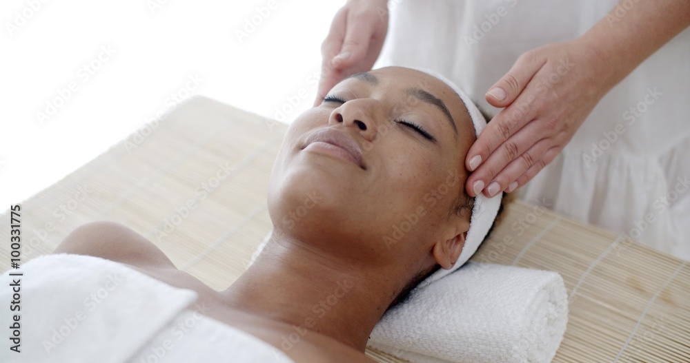 Portrait of young beautiful african american woman in spa environment slow motion