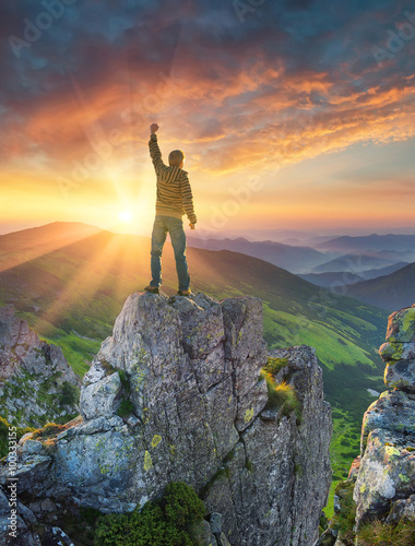 Silhouette of a champion on mountain peak. Active life concept.