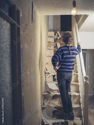 Young woman renovating a staircase © LoloStock