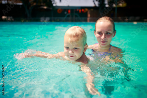closeup mother small daughter swim smile in azure water of pool © SlavaStock