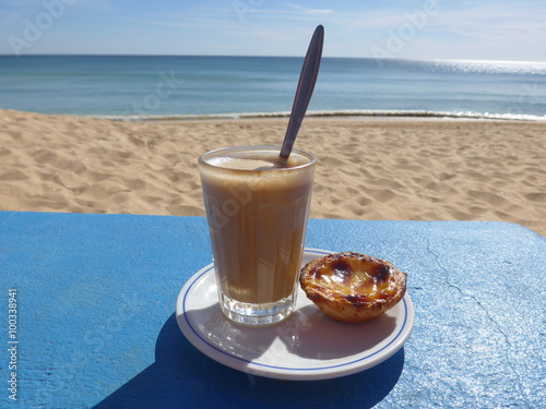 Coffee  at the beach with the ocean in the background photo