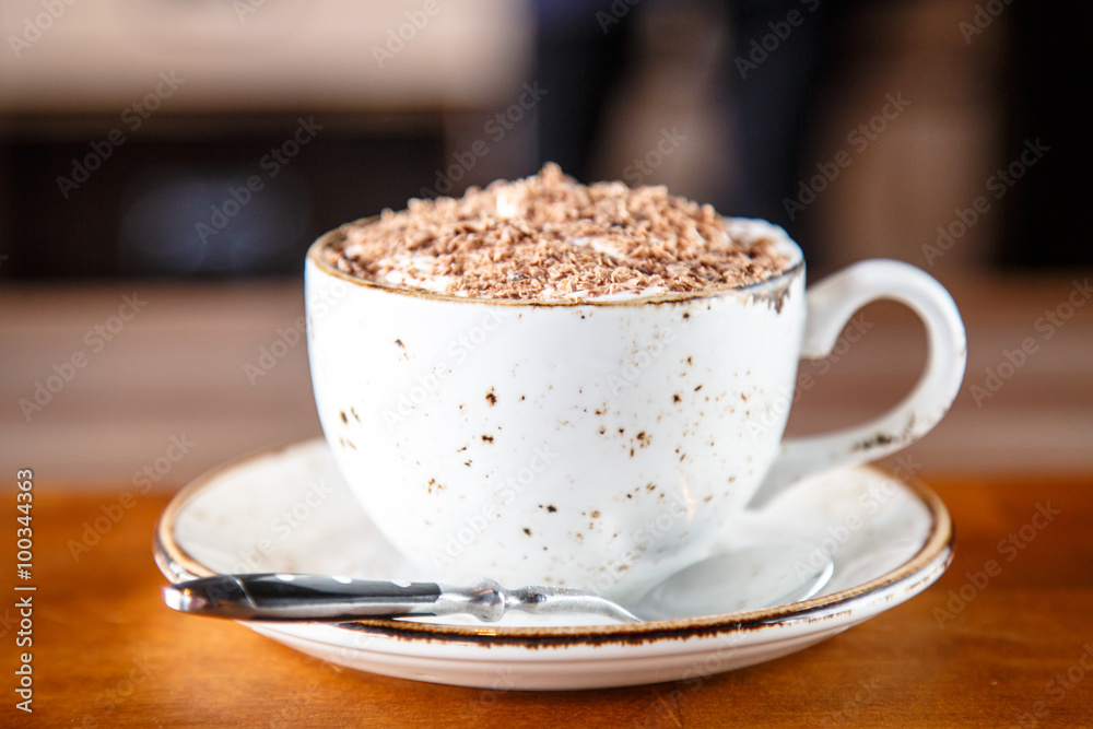 Cup of cappuccino sprinkled with grated chocolate Cup of cappuccino sprinkled with grated chocolate