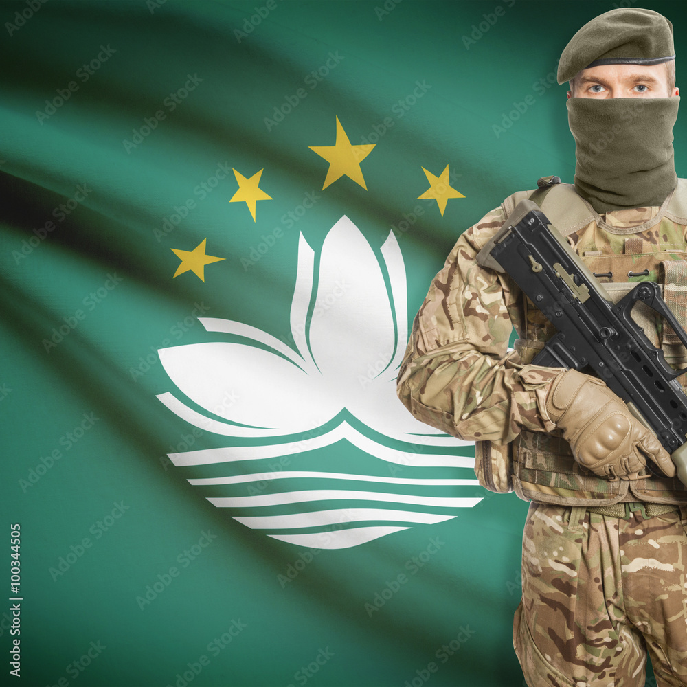 Fototapeta premium Soldier with machine gun and flag on background - Macau