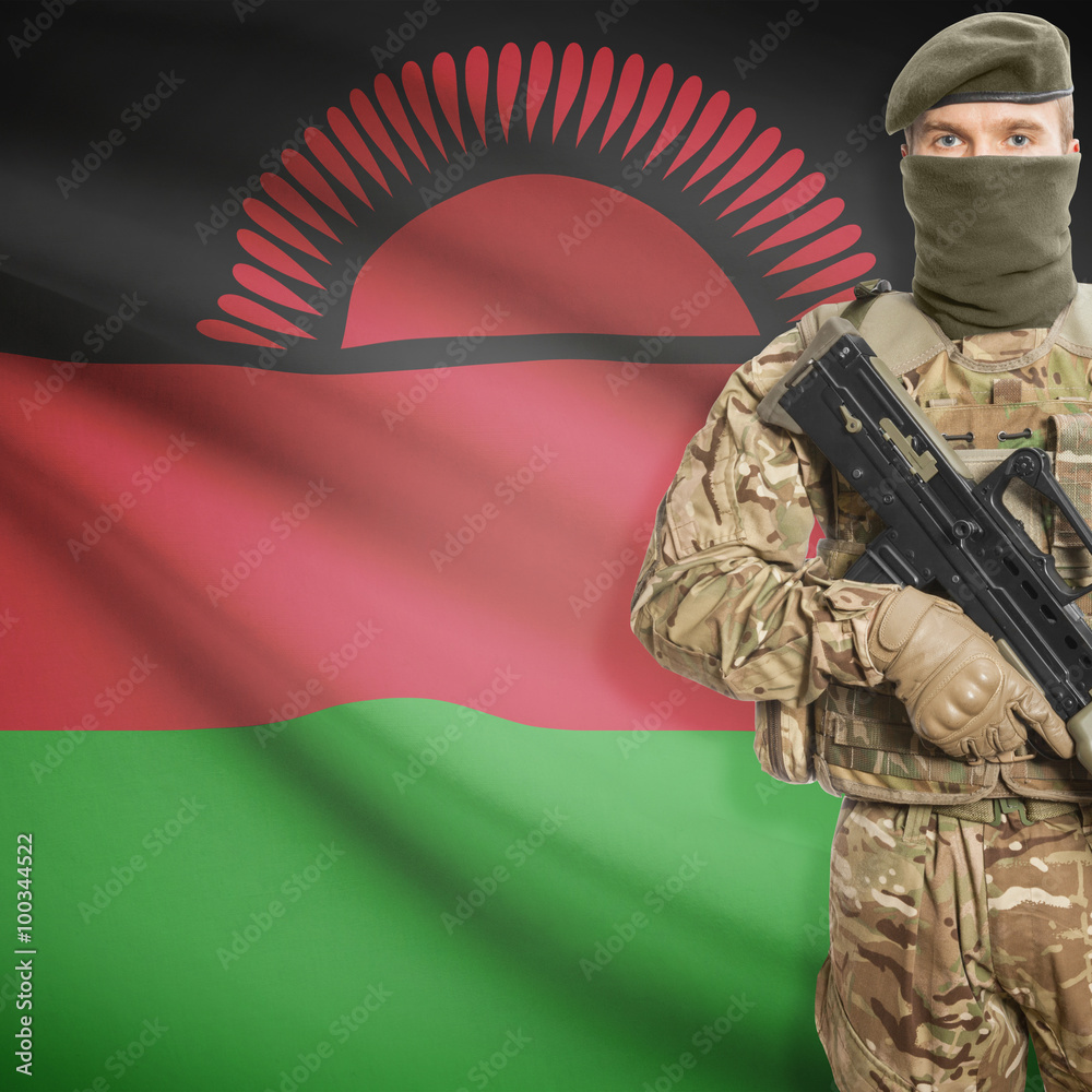 Fototapeta premium Soldier with machine gun and flag on background - Malawi