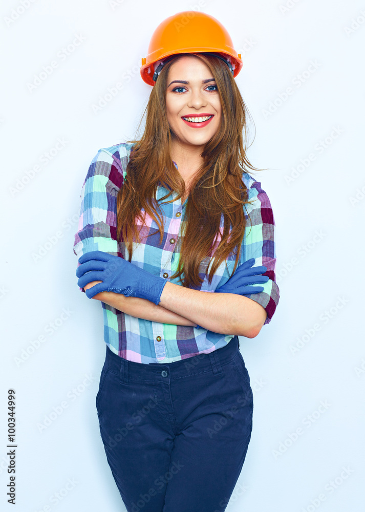 Woman in builder style portrait against white wall. Woman in builder style portrait against white wall.