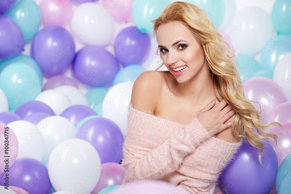 Happy young woman with colorful latex balloons Happy young woman with colorful latex balloons