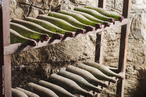 Old dusty wine bottles in the dark cellar