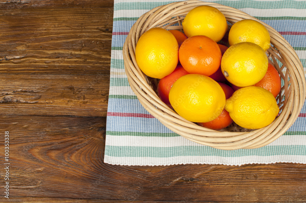 fruits: lemons and oranges on a wooden table fruits: lemons and oranges on a wooden table