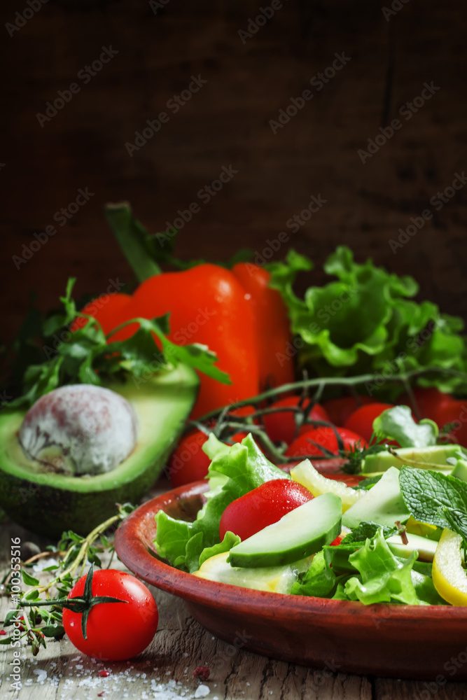Salad with avocado, cherry tomatoes, peppers, cucumbers, herbs,