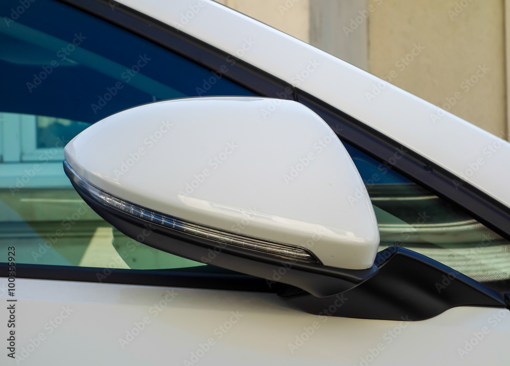 Folded white car sided view mirror Folded white car sided view mirror
