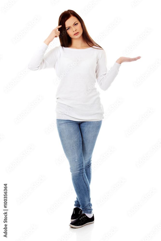 Young student woman holding something on open palm Young student woman holding something on open palm