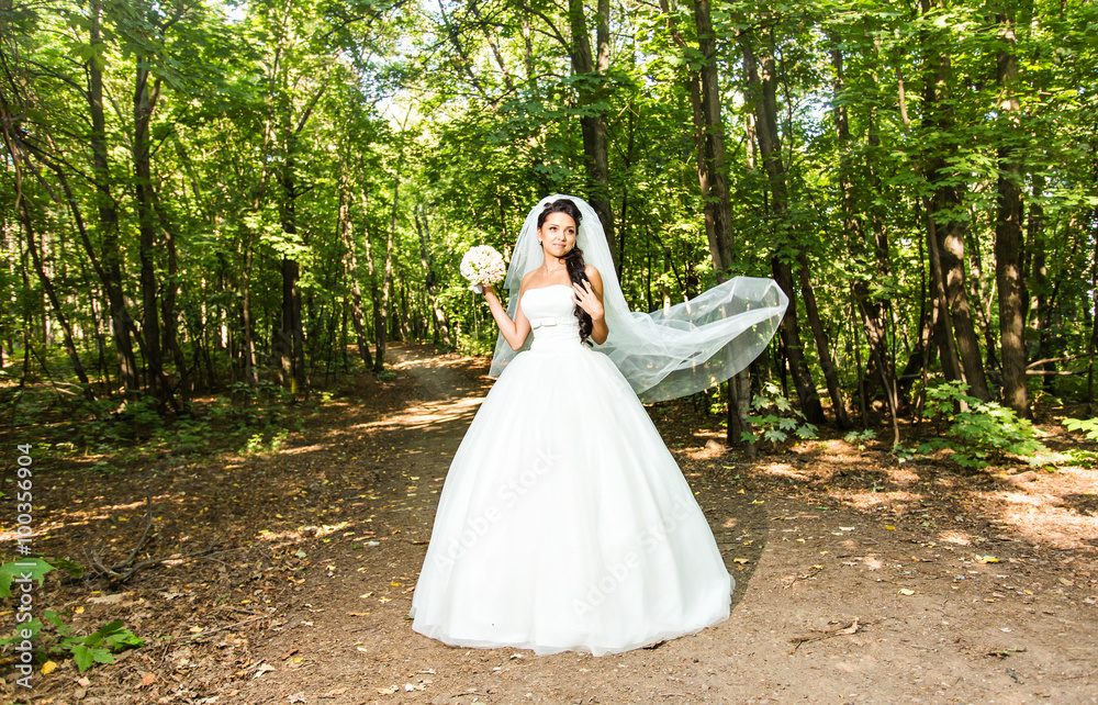 Young bride in wedding dress holding bouquet Young bride in wedding dress holding bouquet