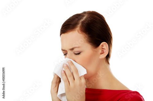 Young beautiful caucasian woman sneezing