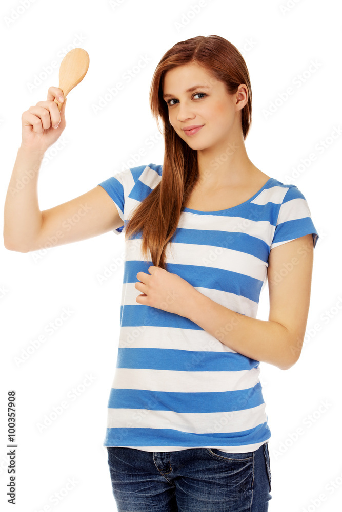 Teenage beautiful woman looking in a mirror Teenage beautiful woman looking in a mirror